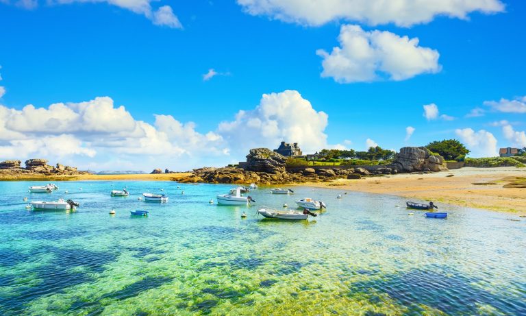 Une eau turquoise époustouflante, des bateaux et une plage de sable fin en Bretagne, en France. Un paysage côtier magnifique.
